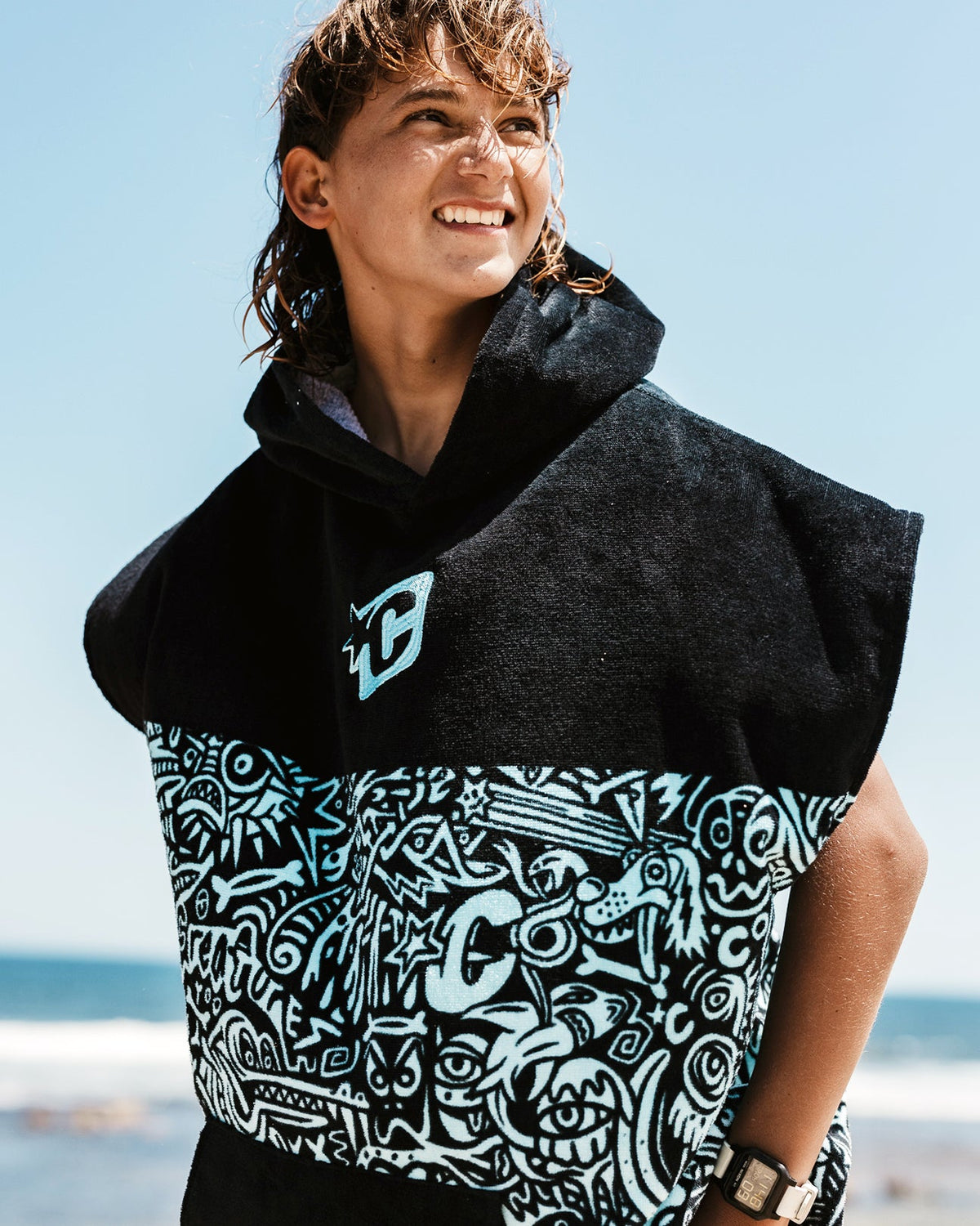 Creatures Grom Poncho in Fluro Blue Fade Black, side view