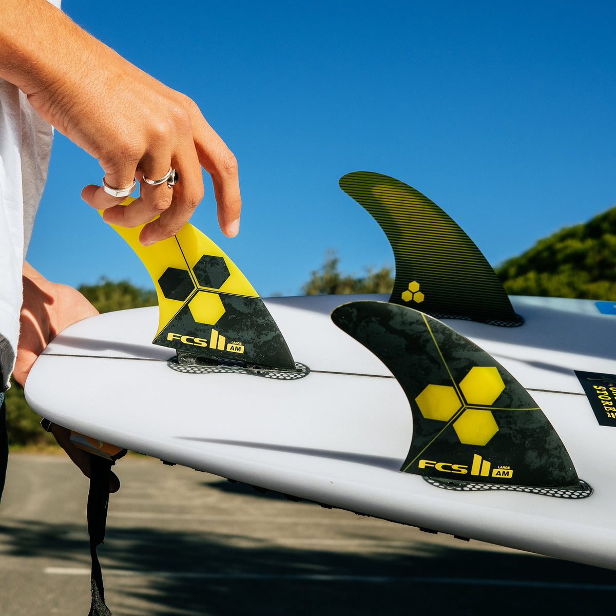 FCS II Al Merrick PC Tri Fins being fitted to a board