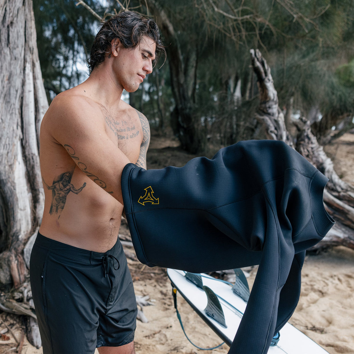 Xcel Mens Drylock Long Sleeve Jacket 2mm pullover top being put on over boardshorts